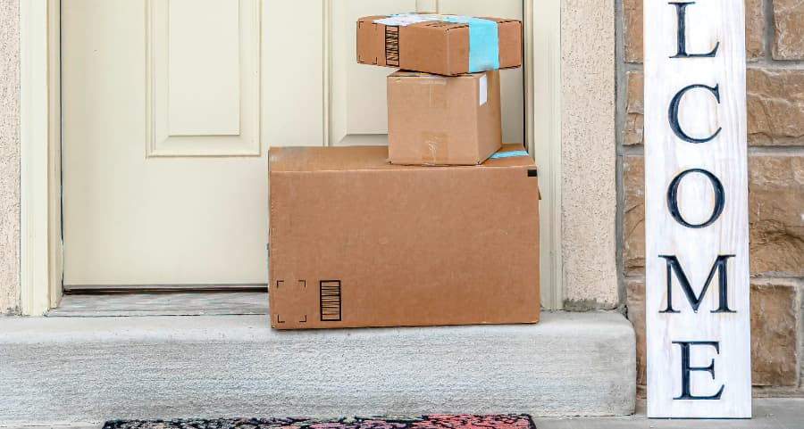 Packages on the doorstep of a home with a welcome sign in San Bernadino